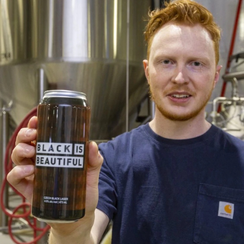 Matt Cummings of Equals Brewing displays their new beer, a Czech black lager called Black is Beautiful.
